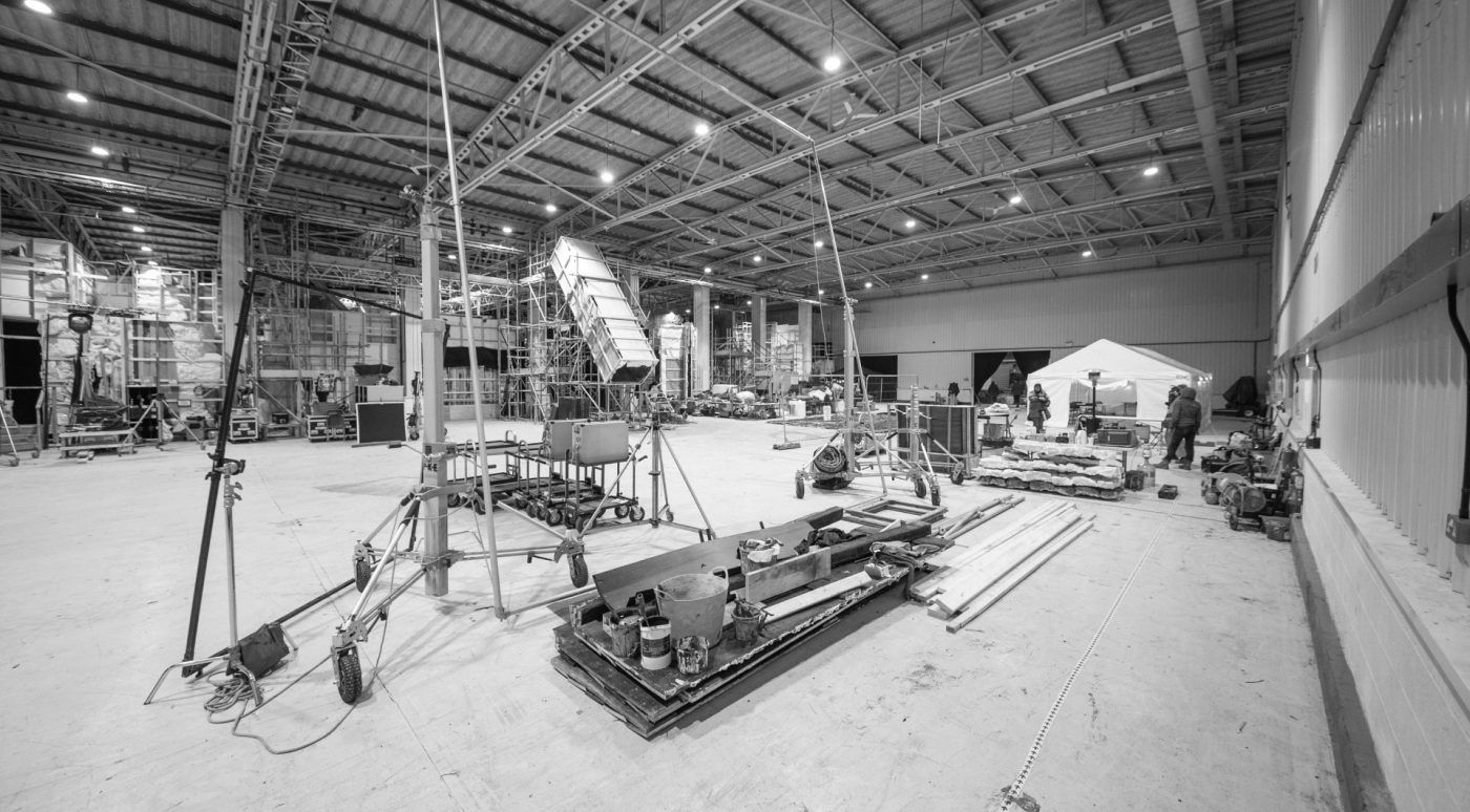 Crew rigging a set build on a stage